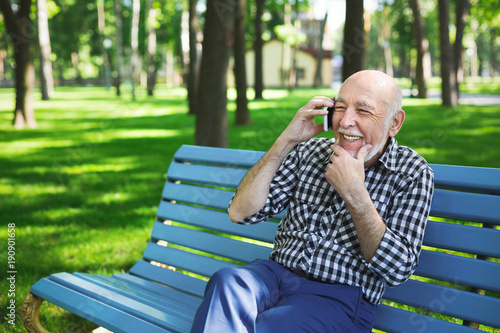 Senior man with mobile outdoors