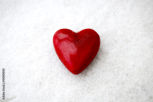 red heart-shaped Valentine figurine on the snow