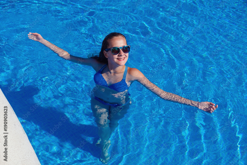 teen girl relaxing near swimming pool