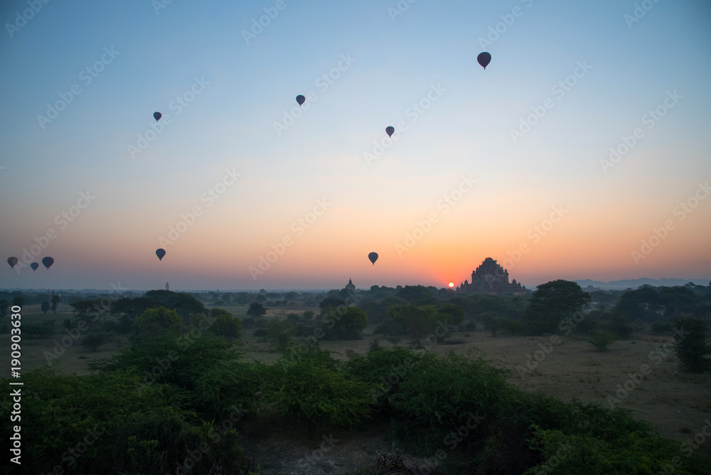 Beautiful landscape view sunrise of pagoda with balloons in Bagan city, Myanmar. A romantic great place for travel.
