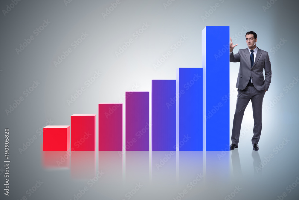 Businessman standing next to bar chart in business concept Businessman standing next to bar chart in business concept