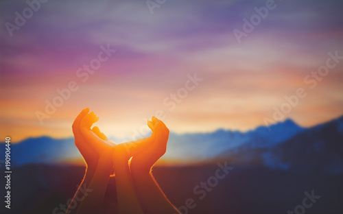 Fototapeta Human hands praying together at dawn