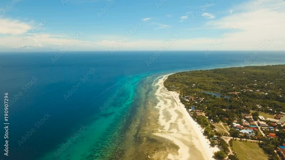 Aerial view of tropical beach on the island Bohol, Anda area, Philippines. Beautiful tropical island with sand beach, palm trees. Tropical landscape: beach with palm trees. Seascape: Ocean, sky, sea Aerial view of tropical beach on the island Bohol, Anda area, Philippines. Beautiful tropical island with sand beach, palm trees. Tropical landscape: beach with palm trees. Seascape: Ocean, sky, sea