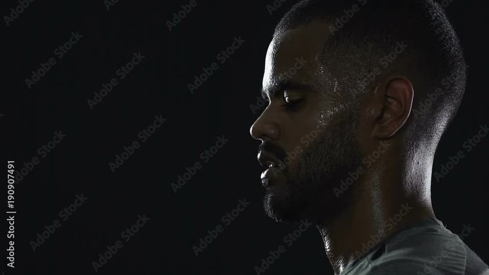 Black tennis player looking at the rival attentively, waiting for revenge chance Black tennis player looking at the rival attentively, waiting for revenge chance
