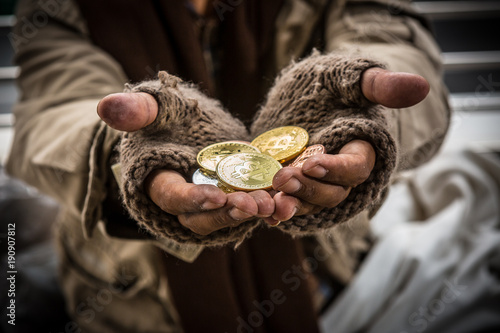 Bitcoin in dirty beggar hand
