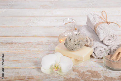 gray natural soap with honey and body oil and a cosmetic face mask with place for tekst