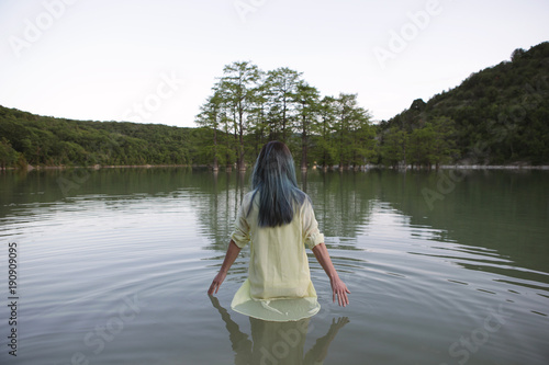 Woman standing in lake. © Anton Sokolov