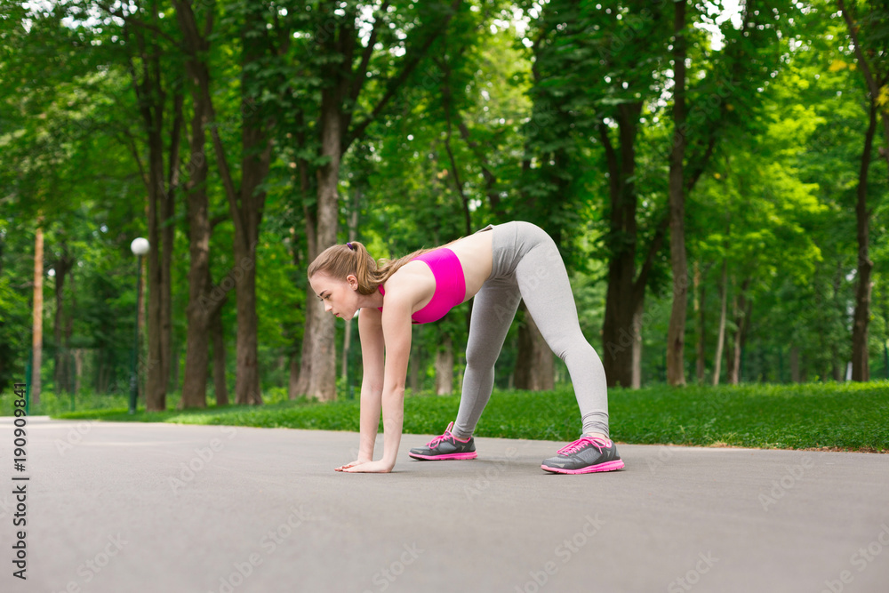 Fototapeta premium Fitness woman at stretching training outdoors