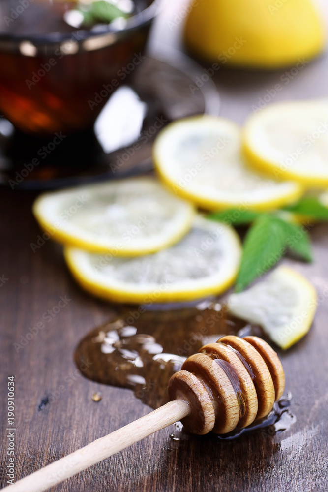 Fresh honey with a cup of black tea Fresh honey with a cup of black tea