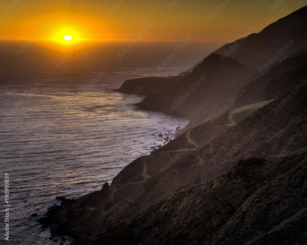 PACIFIC COAST SUNSET AND TRAILS ON HILLSIDE CALIFORNIA