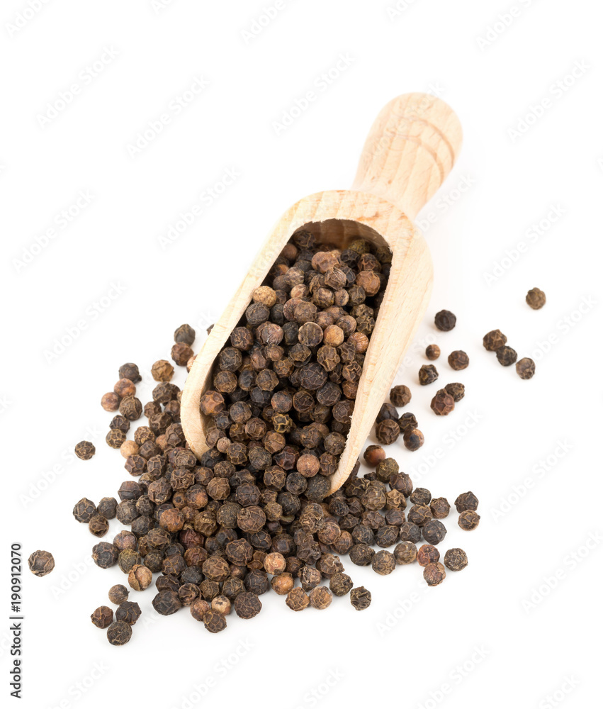 Heap of raw, natural, unprocessed black pepper peppercorns in scoop Heap of raw, natural, unprocessed black pepper peppercorns in scoop