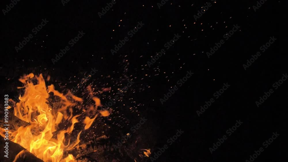 Fire in nature. Bokeh from the fire. Blurred backgrounds. Space views. Sparks are beautifully flying right at you. Shooting speed 180fps, slow motion. Live shooting of the most beautiful flame.