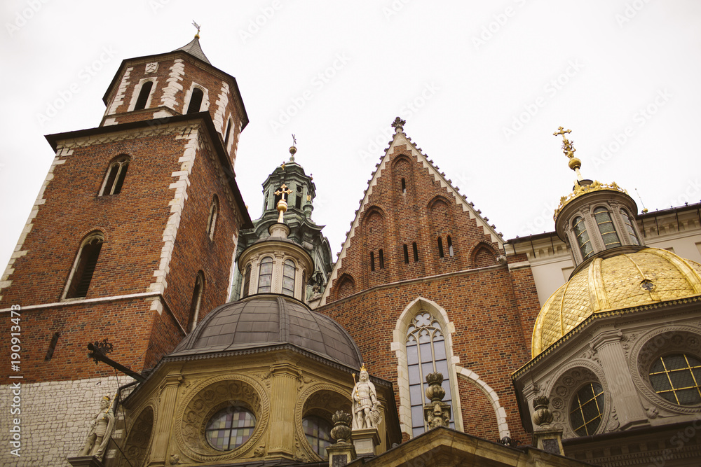 Old city center view with Adam Mickiewicz monument and St. Mary's Basilica in Krakow.