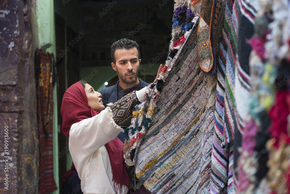 Textiles Musilm Smiling young muslim couple shopping carpets in a textile store Stock ...