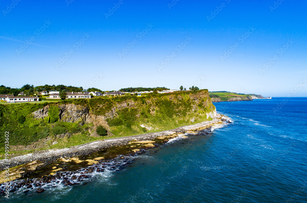 Atlantic coast with steep cliffs at Ballycastle, County Antrim, Northern Ireland, UK. Aerial view
