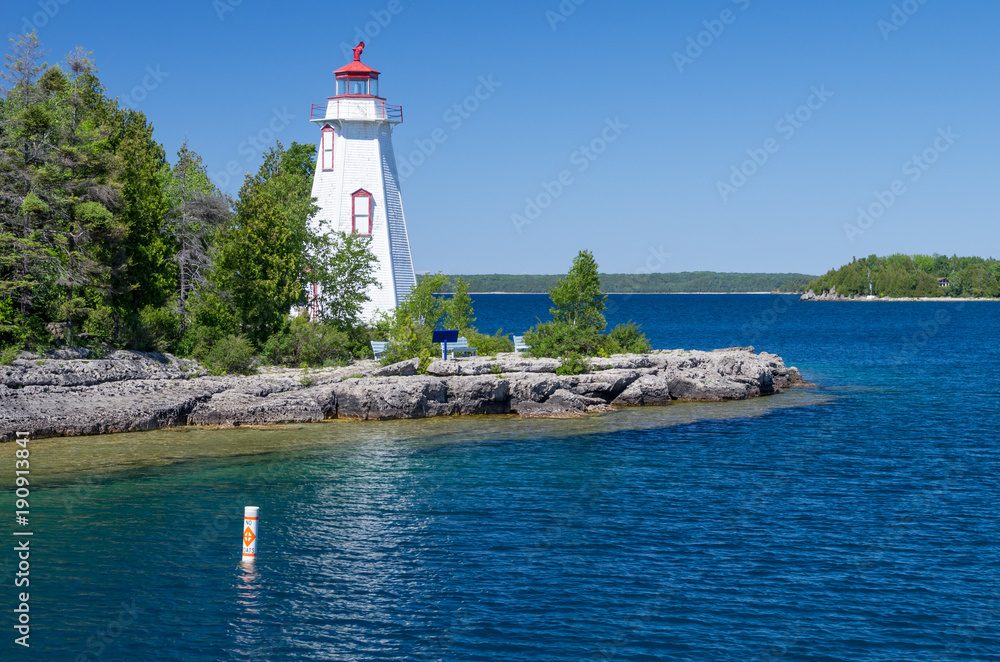 Small White Lighthouse Beside Deep Blue Waters
