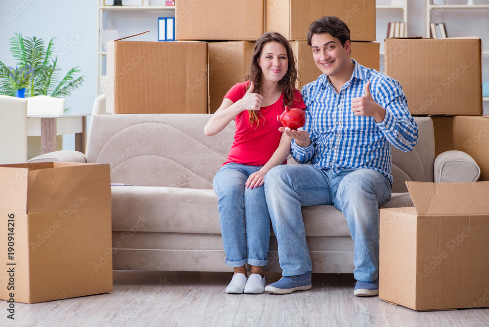 Young pair moving in to new house with boxes Young pair moving in to new house with boxes