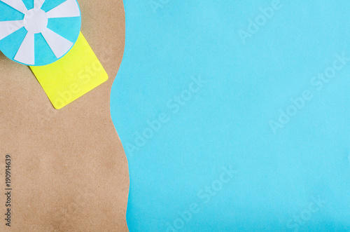 Summer background with beach umbrella and mat. Paper cut.