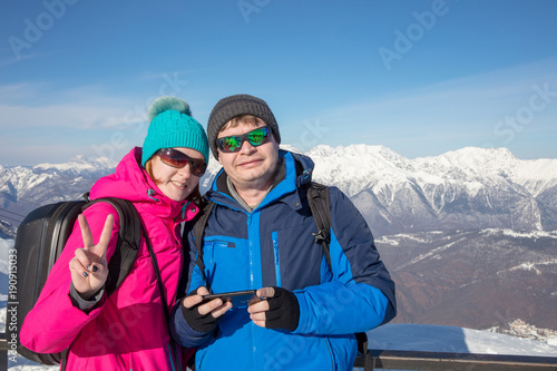 young couple on background of snowy mountain