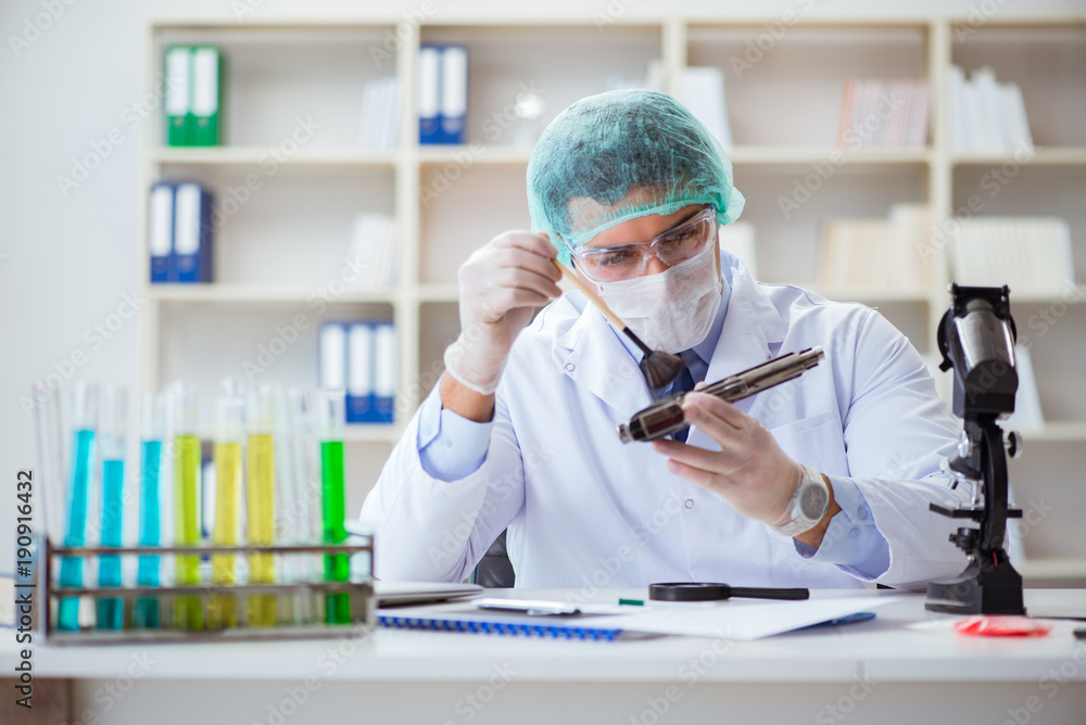Forensics investigator working in lab on crime evidence Forensics investigator working in lab on crime evidence