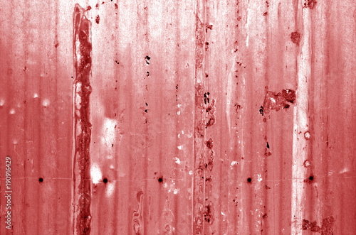 Grungy metal wall in red tone. © pavelalexeev