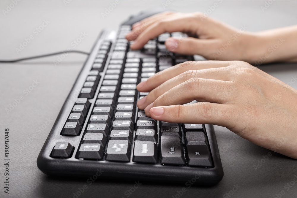 female hands on the keyboard side view female hands on the keyboard side view