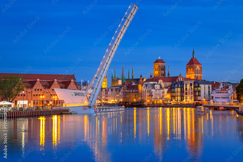 Old town in Gdansk and catwalk over Motlawa river at dusk, Poland