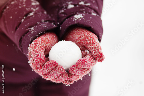 Close up of woman holding the snowball in hands, winter concept with copy space