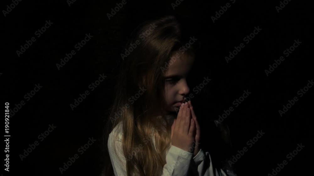A little girl says a prayer before bedtime A little girl says a prayer before bedtime