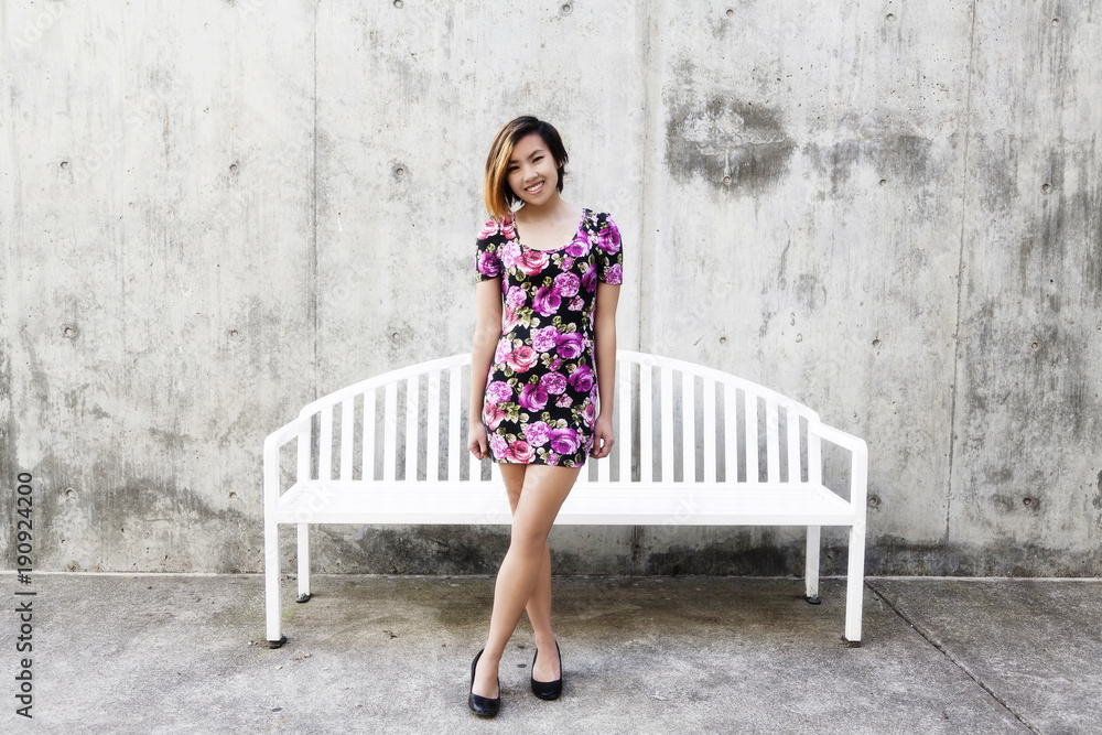 Smiling Asian American Woman Standing In Floral Dress Smiling Asian American Woman Standing In Floral Dress