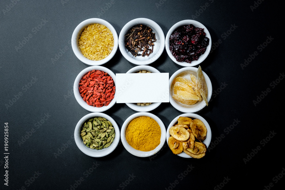 Spices and herbs on a black background with a place for the text on the business card Spices and herbs on a black background with a place for the text on the business card
