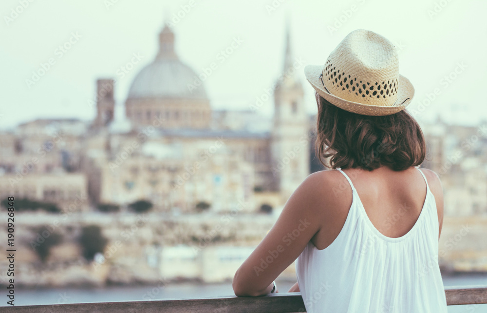 Young woman tourist watching Valletta - Malta  cityscape in summer 