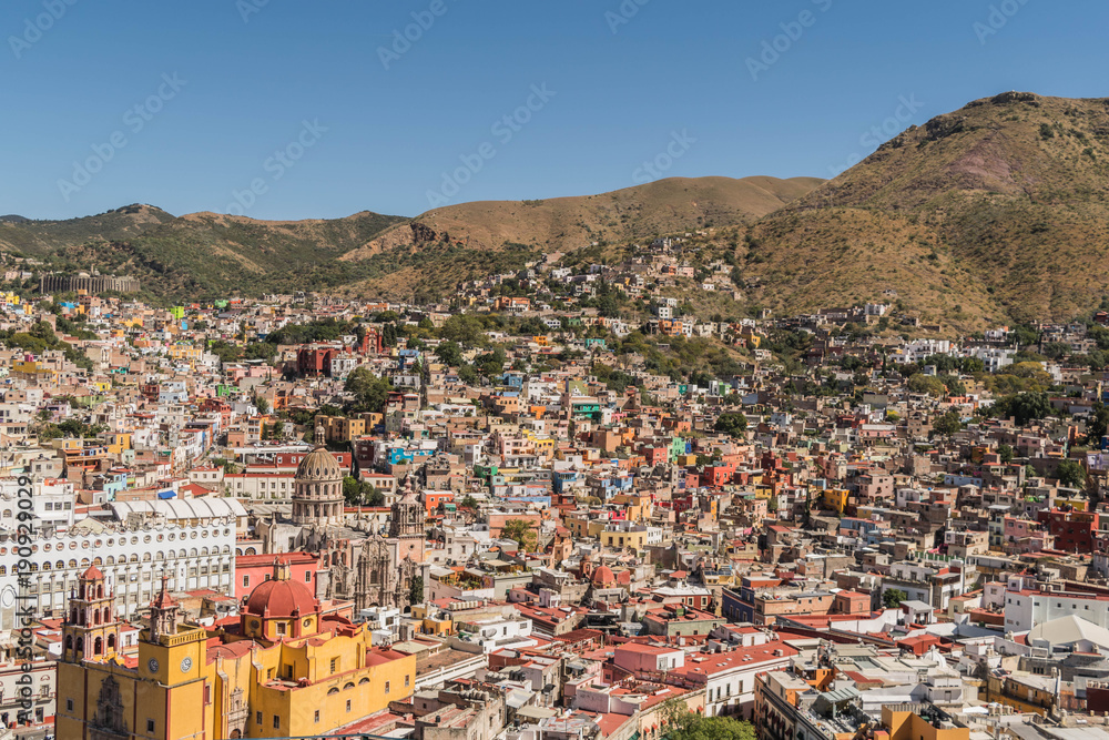 Looking down from above, on a UNESCO Heritage Site-Guanajuato City, Mexico, from up on a hill, with a view of the Basilica, Guanajuato University, many other buildings and colorful houses