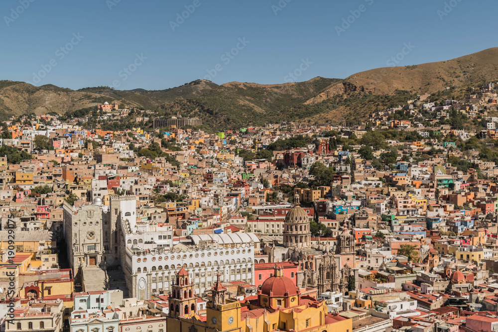 Looking down on a UNESCO Heritage Site-Guanajuato City, Mexico, from up on a hill, with a view of the Basilica, Guanajuato University, many other buildings and colorful houses