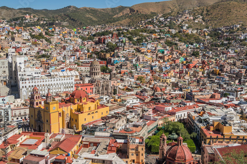 Fototapeta Naklejka Na Ścianę i Meble -  A UNESCO Heritage Site-Guanajuato City, Mexico, from up on a hill, with a view of the Basilica, Guanajuato University, many other buildings and colorful houses