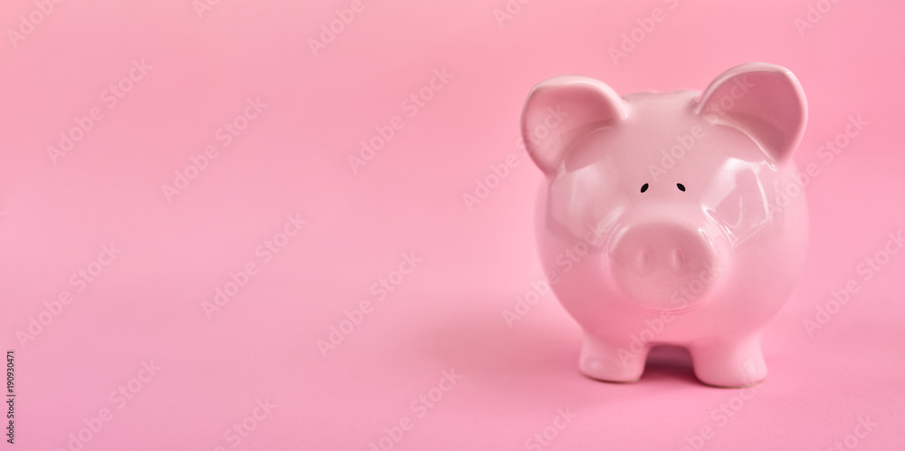 Pink piggy bank over pink background