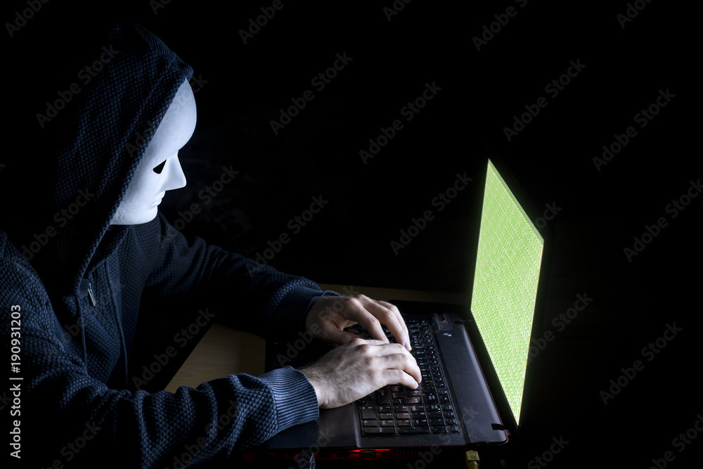 Young hacker on a dark background Young hacker on a dark background