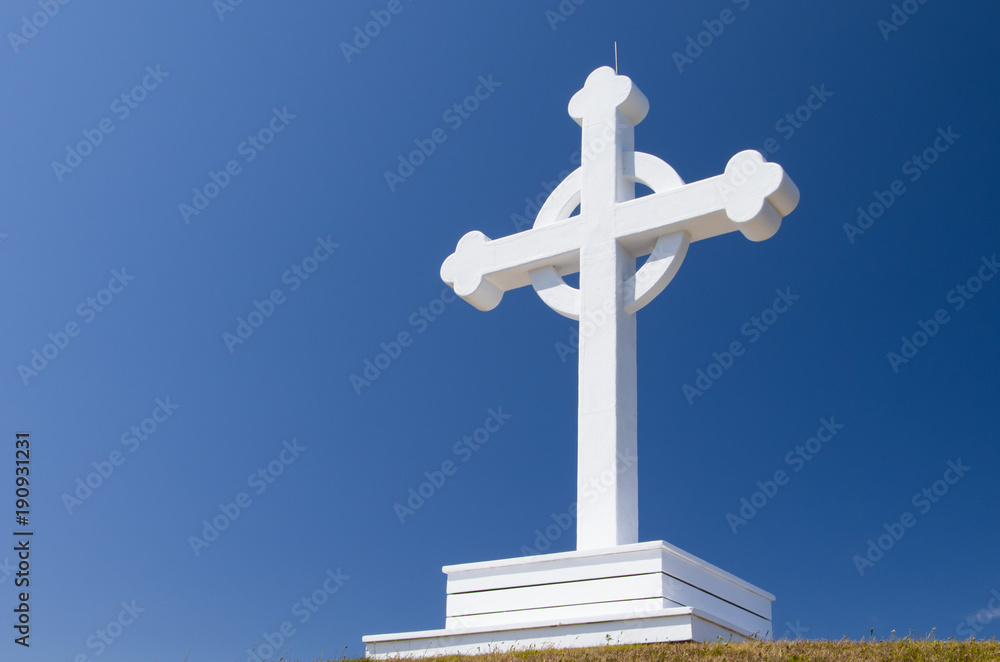 A White Cross Against Dark Blue Sky