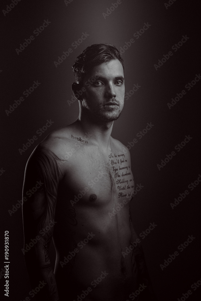 Naklejka premium Young handsome man with tattoos