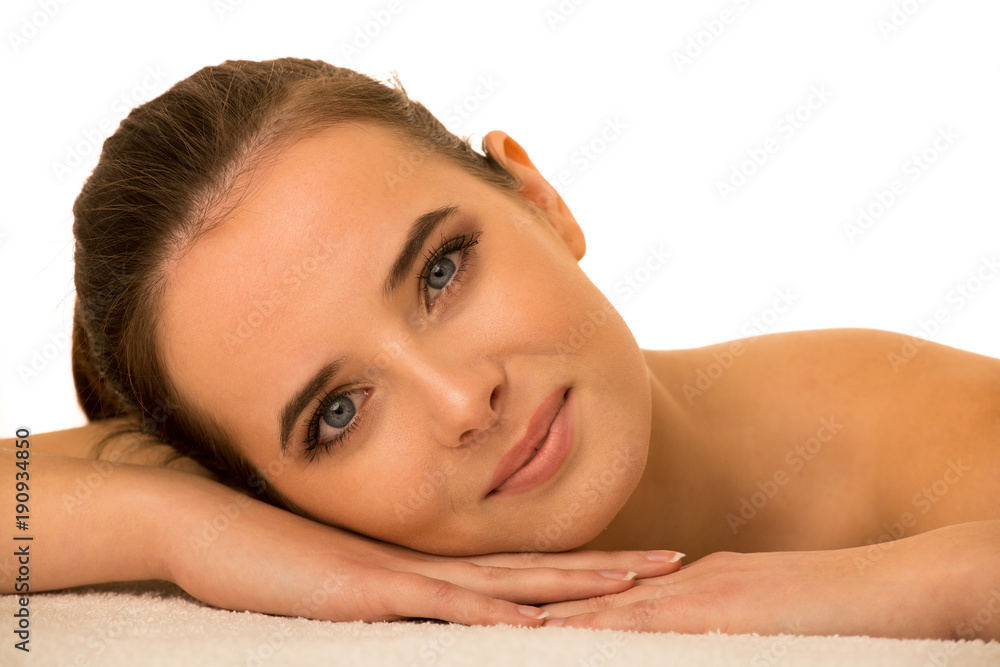 Skin care - beauty portrait of cute caucasian woman lying on table covered with white towel Skin care - beauty portrait of cute caucasian woman lying on table covered with white towel