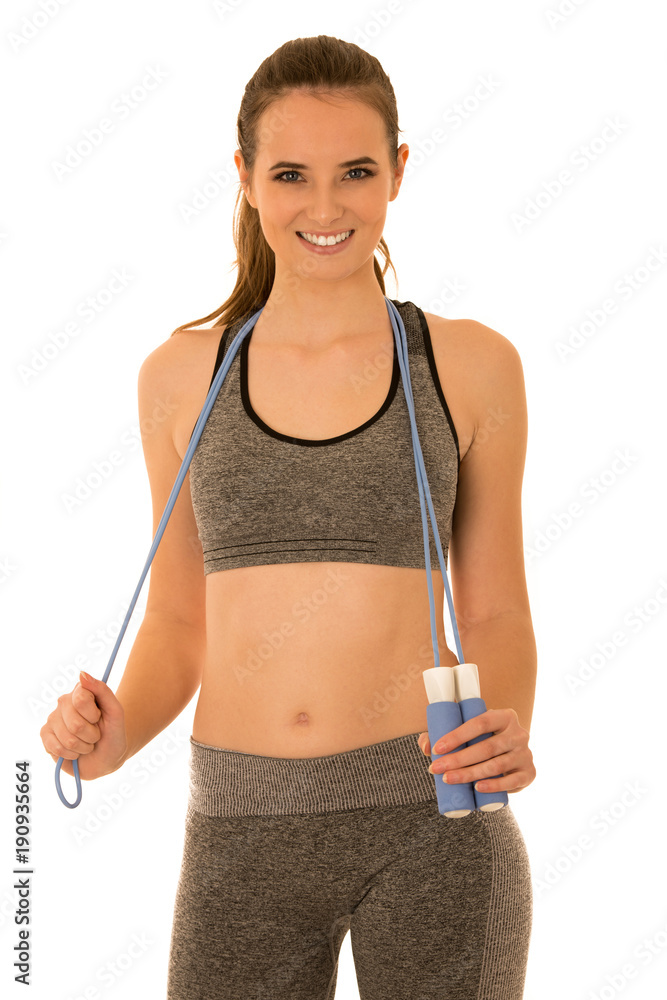 Beautiful young fit woman works out with speed rope isolated over white background Beautiful young fit woman works out with speed rope isolated over white background