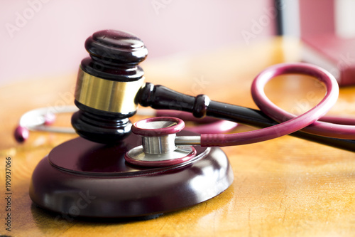 Medical law concept. Gavel and stethoscope on wooden table