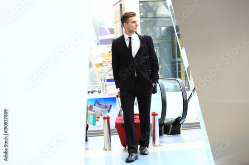 Business man at airport with suitcase