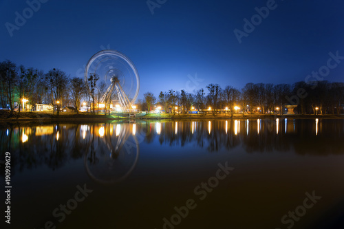 a Ferris wheel in a night park on a long exposure