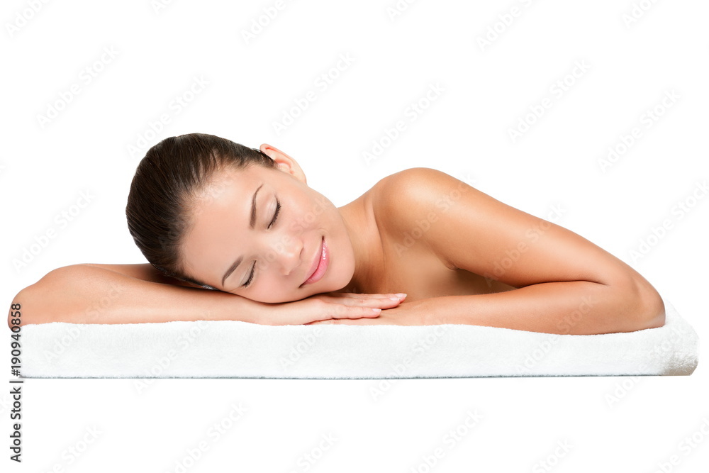 Spa. Face skincare beauty woman smiling happy. Beautiful attractive mixed race Chinese Asian / Caucasian female model lying down on towel during skin care treatment isolated on white background. Spa. Face skincare beauty woman smiling happy. Beautiful attractive mixed race Chinese Asian / Caucasian female model lying down on towel during skin care treatment isolated on white background.