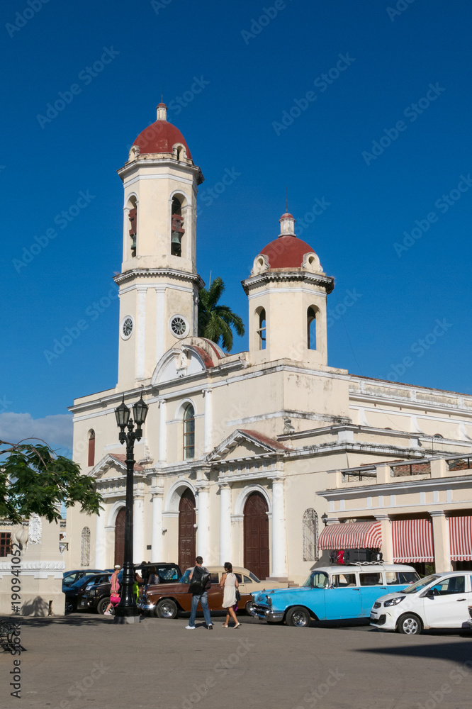 Old cars parked in the Jose Marti Park, in front of the Purisima Concepcion Cathedral. Cienfuegos, Cuba.