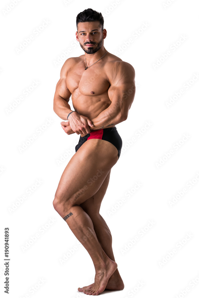 Handsome shirtless bodybuilder man, standing, in studio shot, looking at camera, isolated on white Handsome shirtless bodybuilder man, standing, in studio shot, looking at camera, isolated on white