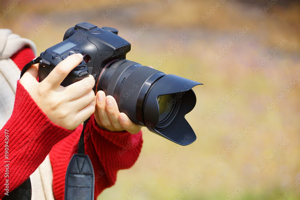 Fototapeta premium Hand holding a digital camer with copy space to add text
