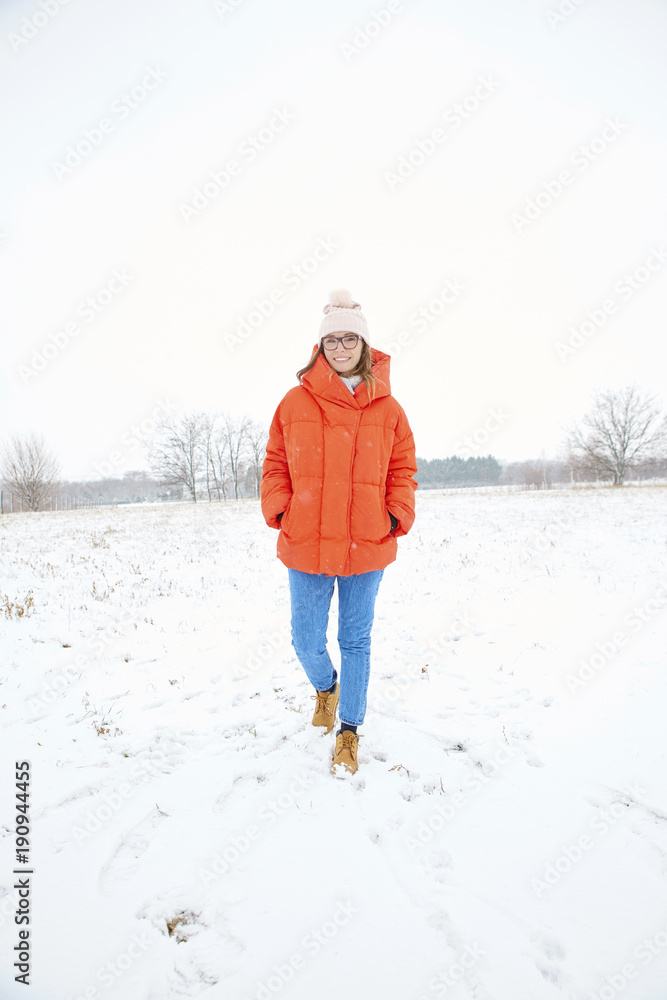 Full length shot of a happy woman enjoy winter weather outdoor and walking alone. Full length shot of a happy woman enjoy winter weather outdoor and walking alone.