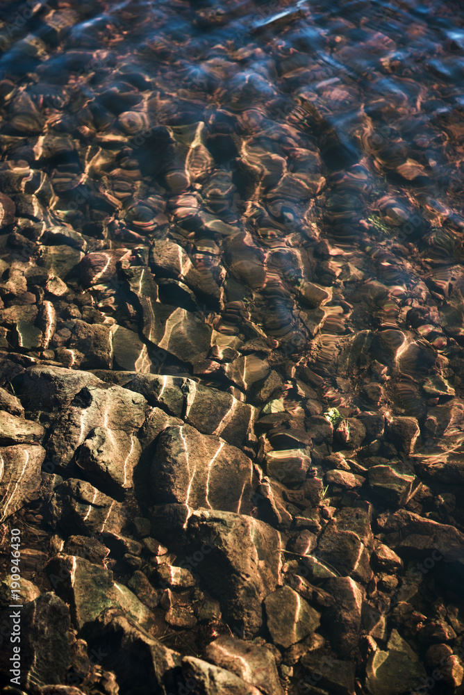 Naklejka premium water rocks in river shallow
